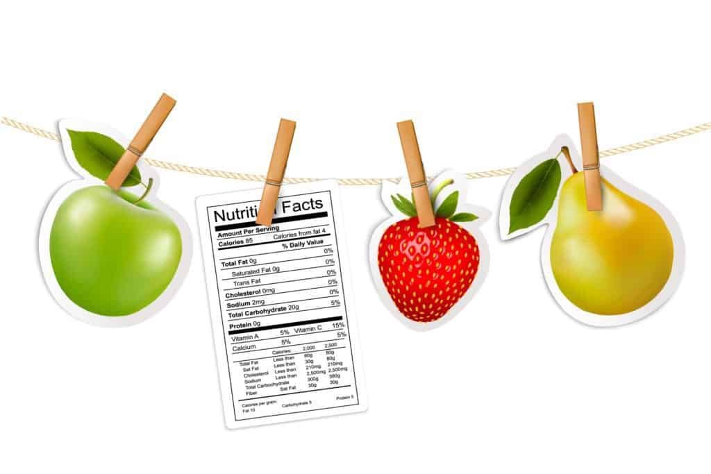 Fruit stickers and a nutrition label hanging on a rope