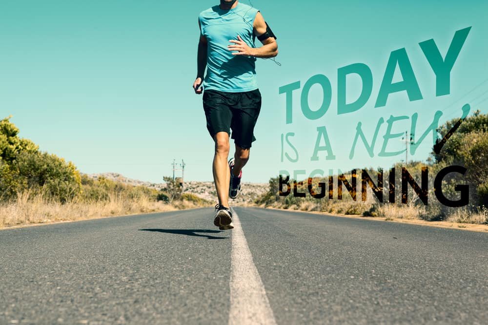 Athletic man jogging on open road against today is a new beginning