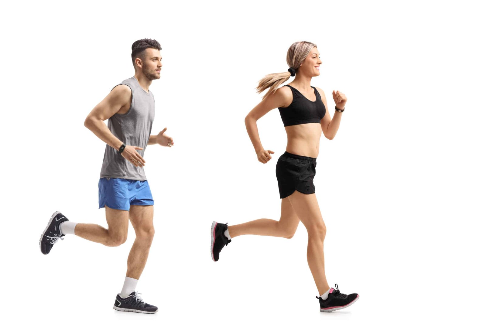 Full length profile shot of a young man and a young woman runnin