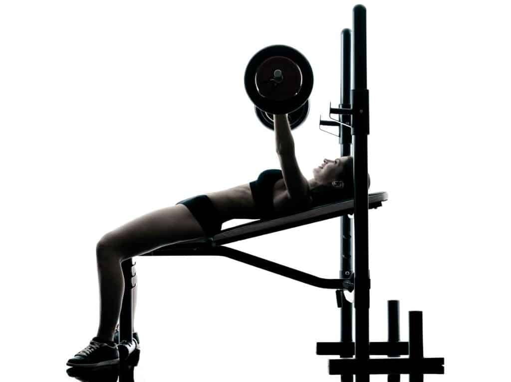 Body building woman doing compound movement