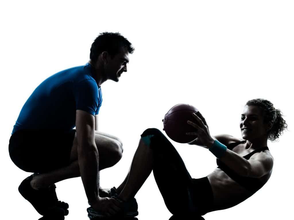 Why You Should Hire A Personal Trainer 3 Man woman exercising weights workout fitness ball
