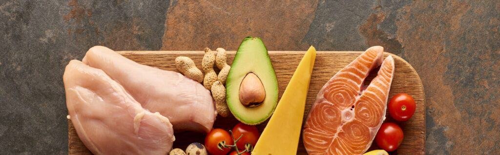 Protein Timing: How To Optimize Your Protein Intake For Muscular Growth 2 Panoramic shot of raw poultry fillet and salmon steak with vegetables