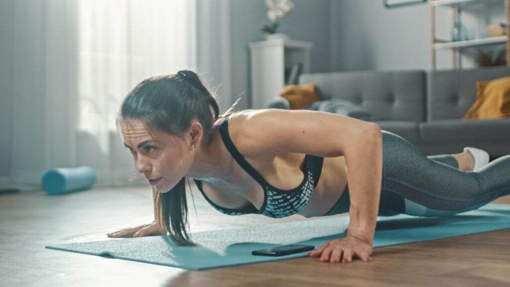 Close Up of a Beautiful Fitness Girl in an Athletic top doing pushups