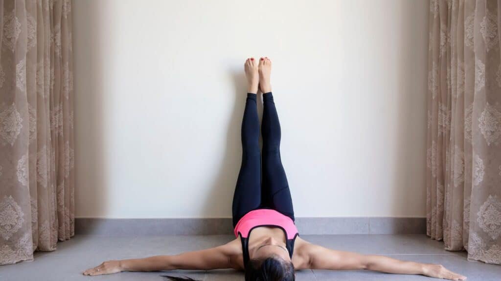 12 Amazing Yoga Poses To Unlock Your Inner Strength 13 Yoga woman performing Legs Up the Wall pose