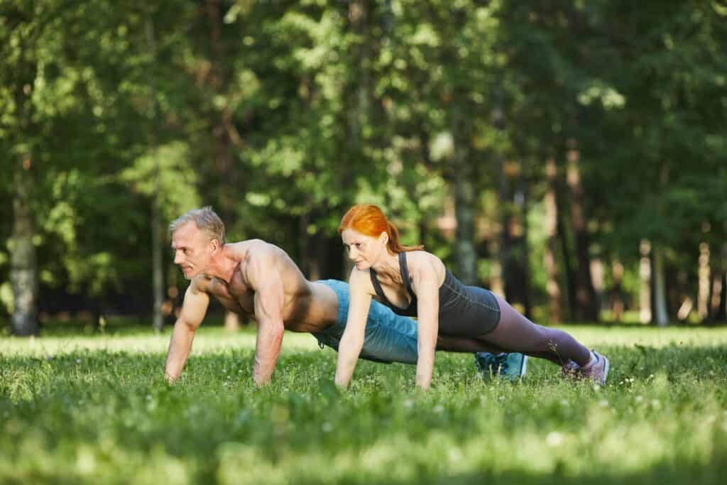 How to Lose Weight After 50: Your Step-by-Step Guide 4 Couple doing push-ups in park