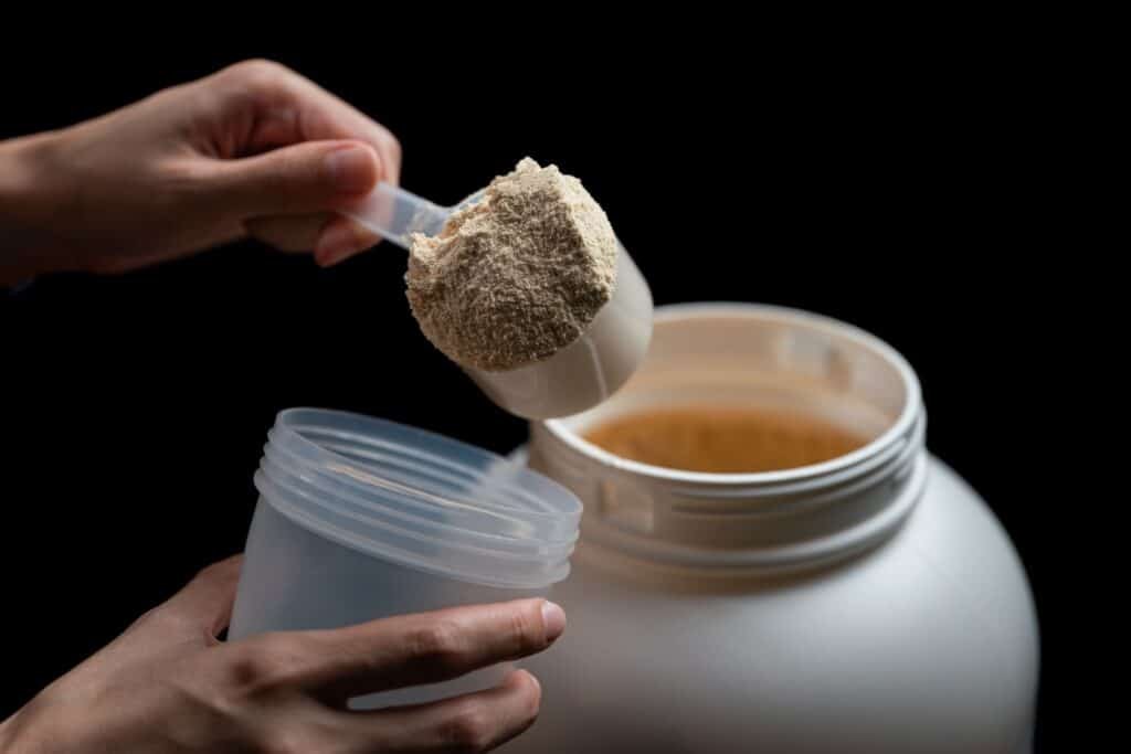 Whey Vs. Casein For Weight Loss-Which Is Best? 3 Close up of women with measuring scoop of whe