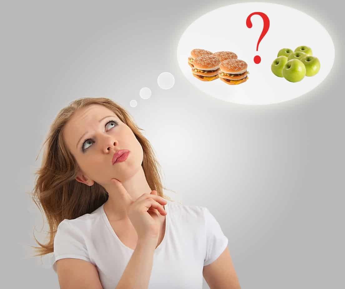 How To Lose Weight Without Dieting: Effective Strategies Explained 1 Attractive young woman makes a choice between healthy and unhealthy food