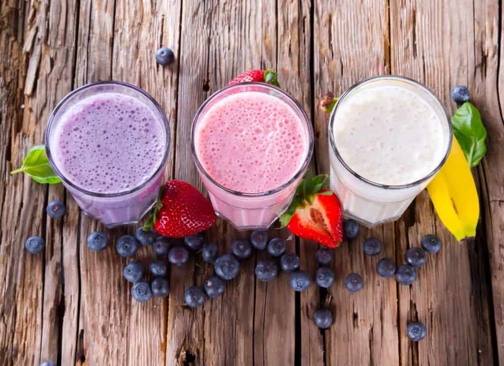 Fuel Your Gains: 10 Nutritious Snacks for Bodybuilders 6 Fresh fruits protein milk shake on wood