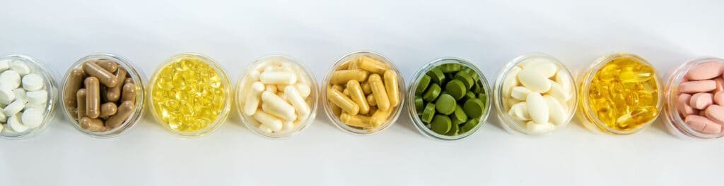 Age Gracefully: Uncover the Best Supplements for Women Over 40 3 Supplements and vitamins on a white background