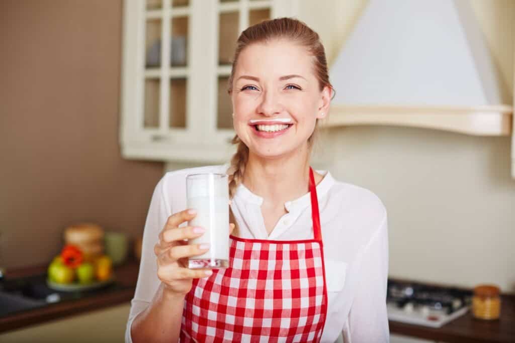 Woman with glass of kefir