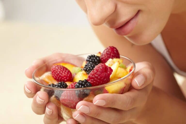 Woman eating fruit salad