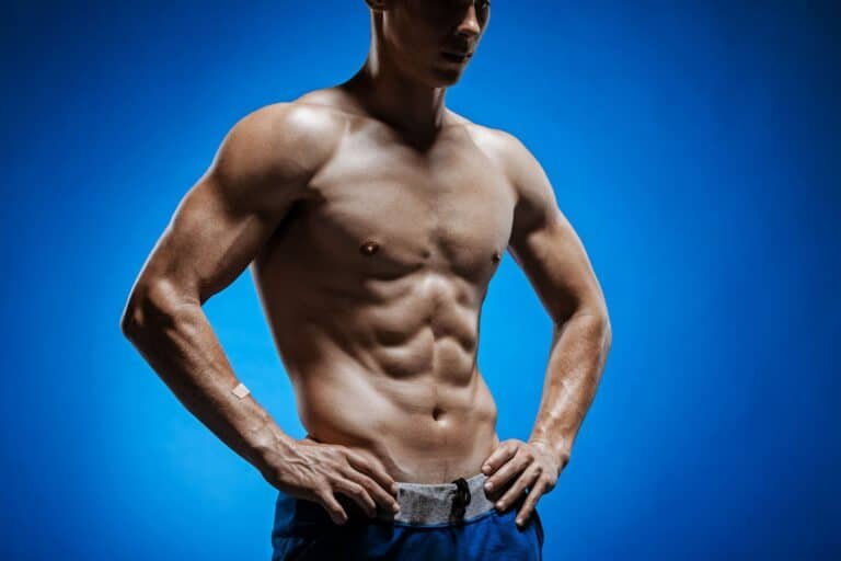 Fit young man with torso on blue background