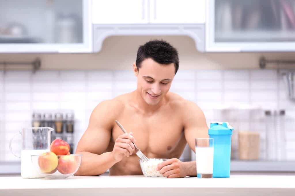 Hungry for Growth?The Best Breakfast Foods For Muscle Gain 2 Handsome muscular young man having healthy breakfast