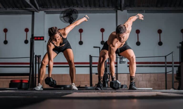 A closeup shot of an athletic male and female in the gym