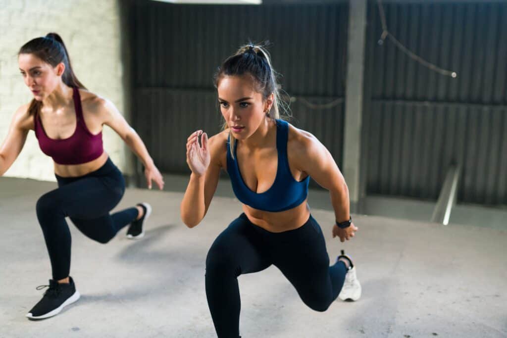 Metabolism Boosters: Unleashing the Power of Anaerobic Exercises for Weight Loss 3 Athletic young woman with a healthy lifestyle doing lunges during HIIT class