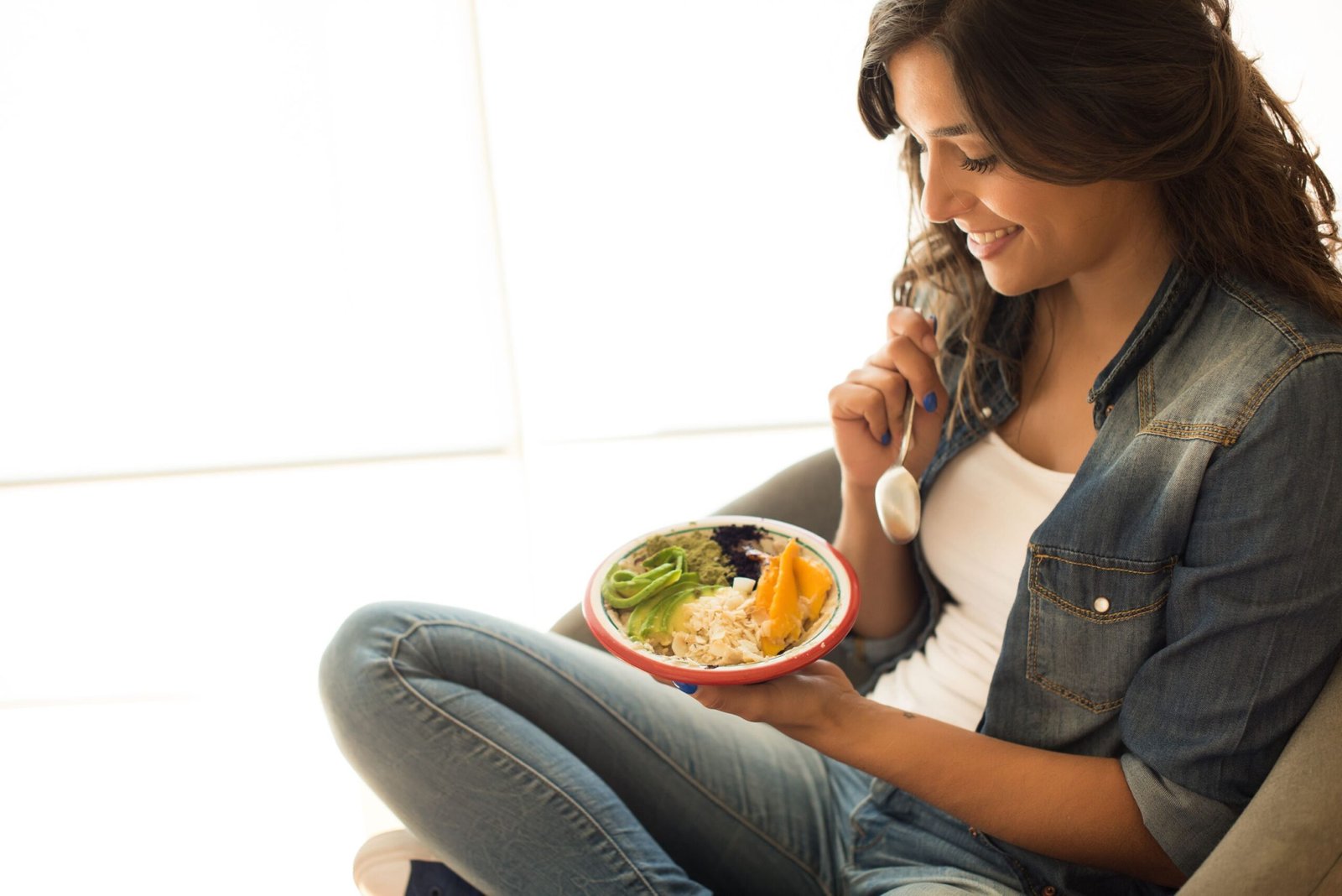 Losing Weight On A Plant-Based Diet: A Step-by-Step Approach 1 Woman eating a healthy bowl of superfoods
