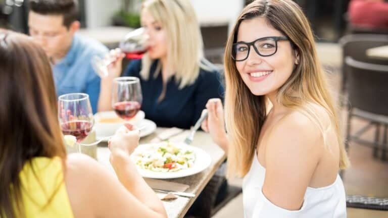 Beautiful woman eating out with friends