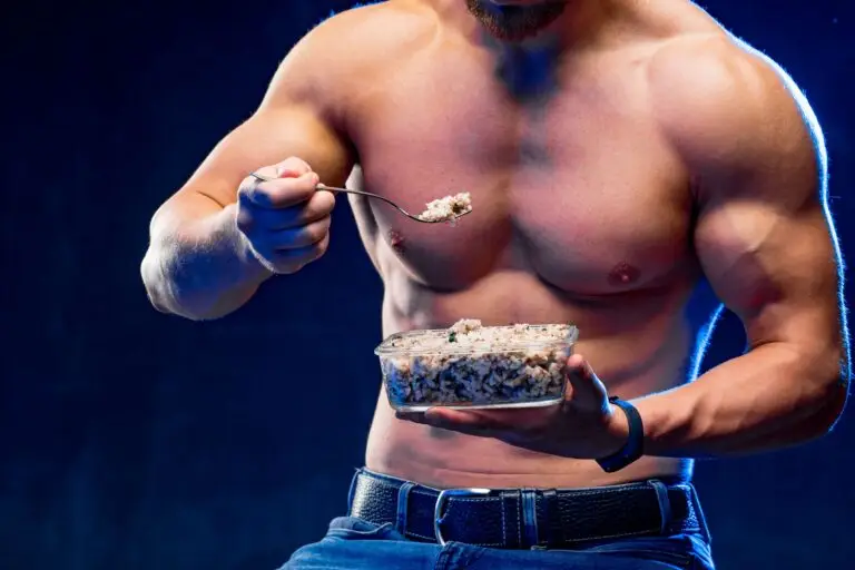 Muscular bodybuilder eating healthy white rice